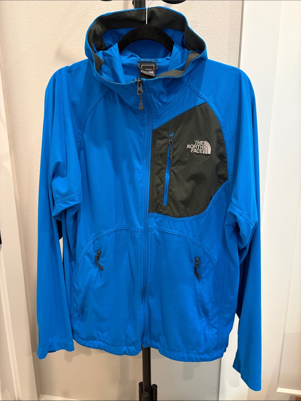 The North Face men’s Blue Jacket with Black Chest Panel and many pockets